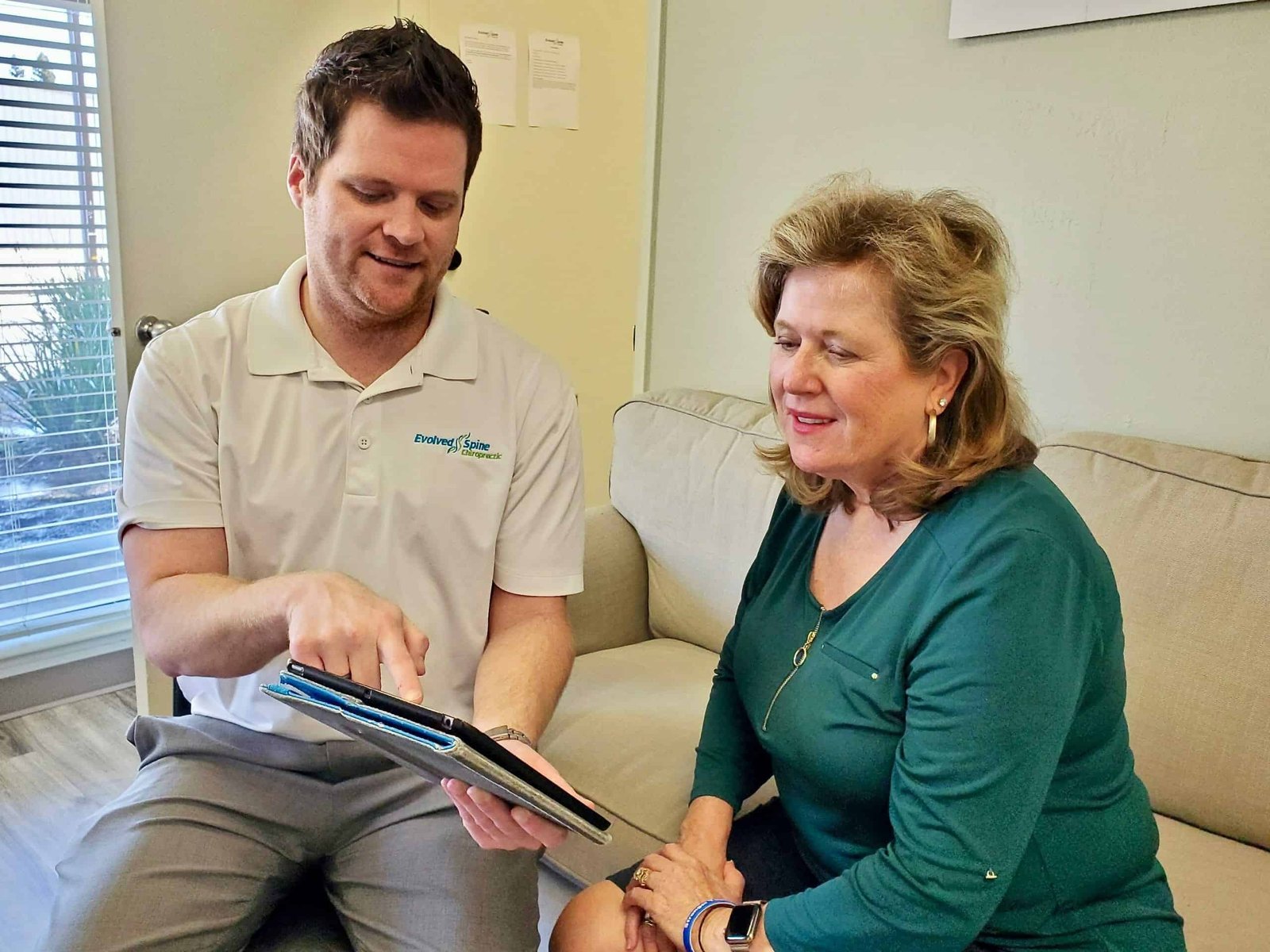 Dr. Dickson Explaining Whiplash To A Patient In Rancho Cordova Dr. Dickson showing how whiplash happens with a diagram to a patient in Rancho Cordova
